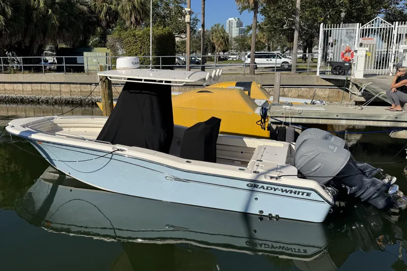 The Image of 2017 Grady-White Fisherman 257 boat docked in a marina, featuring dual outboard engines. - 1