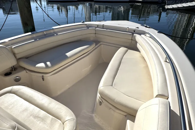 Slide: The Image of 2017 Grady-White Fisherman 257 boat interior with cushioned seating, docked at marina. - 13