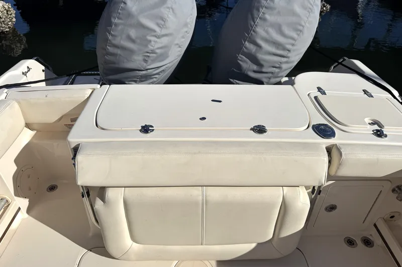 Slide: The Image of 2017 Grady-White Fisherman 257 boat interior with cushioned seating and storage compartments. - 16