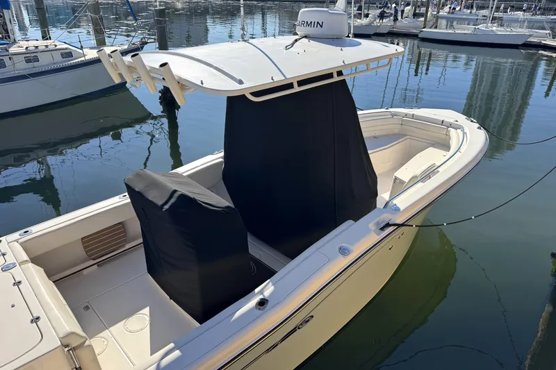 Slide: The Image of 2017 Grady-White Fisherman 257 boat docked in marina, featuring covered seating and Garmin equipment. - 3