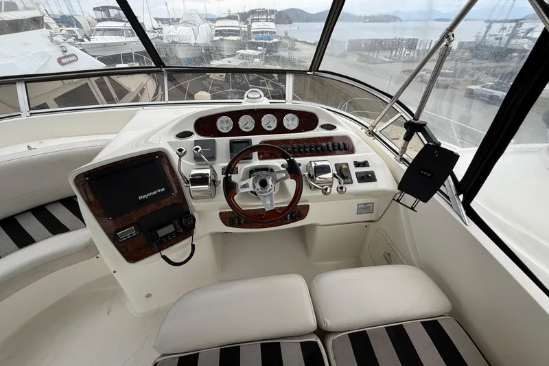 Slide: The Image of Cockpit of 2006 Meridian 411 Sedan yacht with steering wheel and navigation equipment. - 16