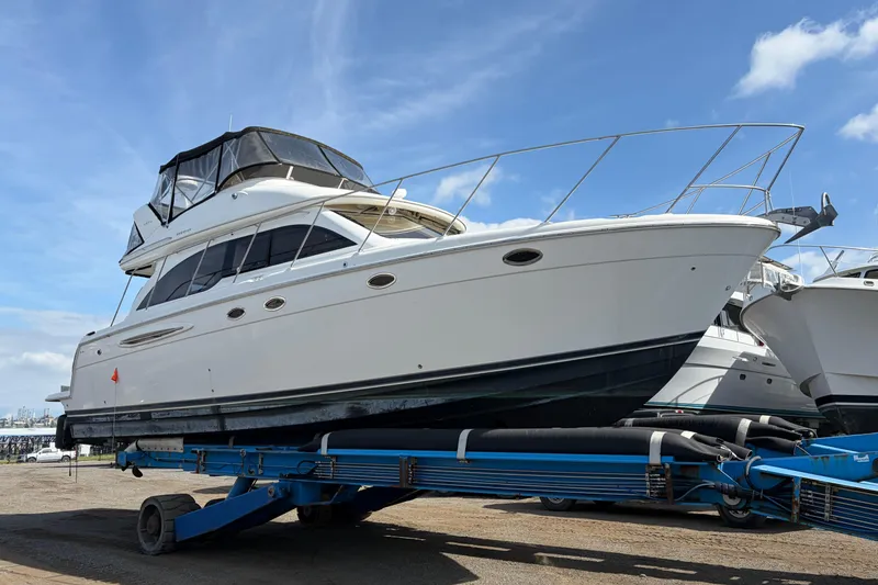 Slide: The Image of 2006 Meridian 411 Sedan yacht on trailer under clear blue sky. - 2