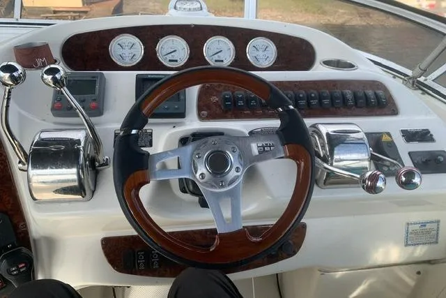 Slide: The Image of Control panel of a 2006 Meridian 411 Sedan yacht with gauges and steering wheel. - 21