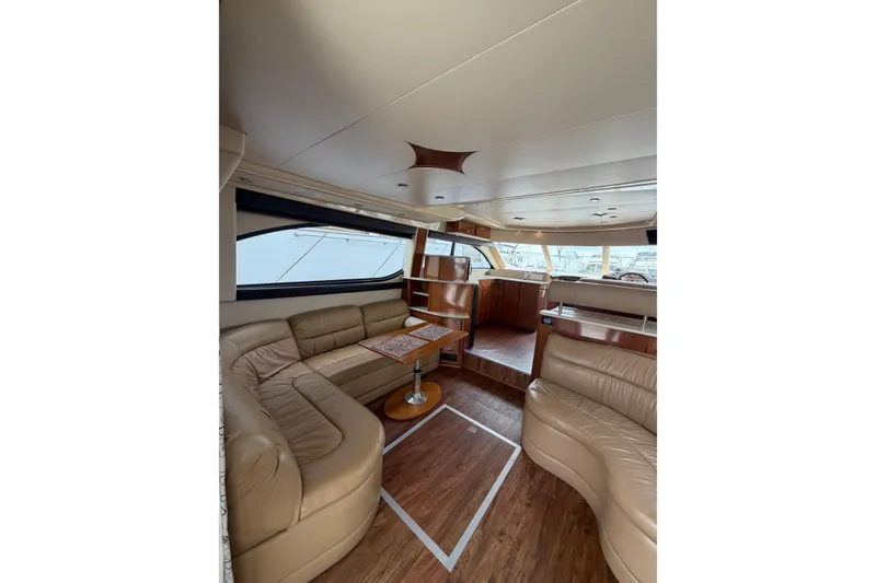 Slide: The Image of Luxurious interior of a 2006 Meridian 411 Sedan yacht with leather seating and wooden accents. - 24