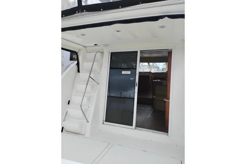 Slide: The Image of 2006 Meridian 411 Sedan yacht interior with sliding glass door and staircase. - 25