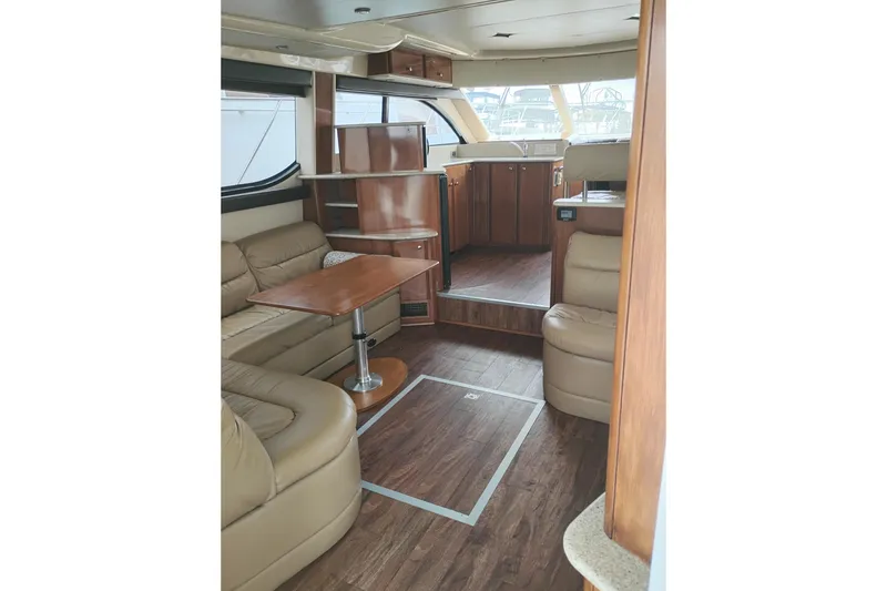 Slide: The Image of Luxurious interior of a 2006 Meridian 411 Sedan yacht with leather seating and wooden accents. - 26