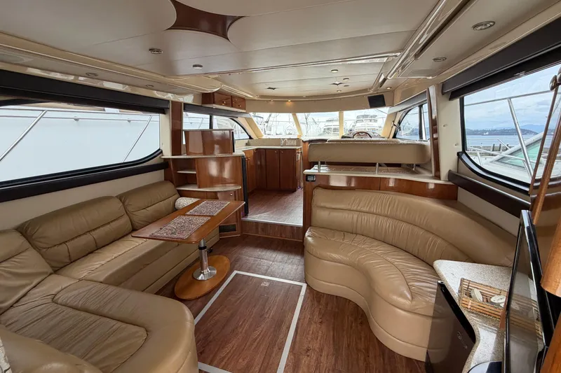 Slide: The Image of Luxurious interior of a 2006 Meridian 411 Sedan yacht with leather seating and wood accents. - 31