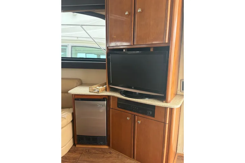 Slide: The Image of Interior of 2006 Meridian 411 Sedan with TV, mini-fridge, and wooden cabinetry. - 32