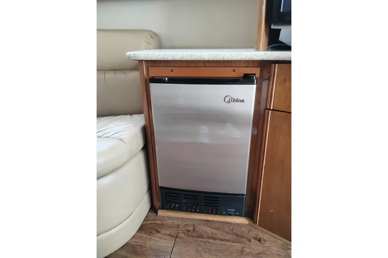 Slide: The Image of Compact refrigerator in 2006 Meridian 411 Sedan yacht interior, next to beige seating. - 33