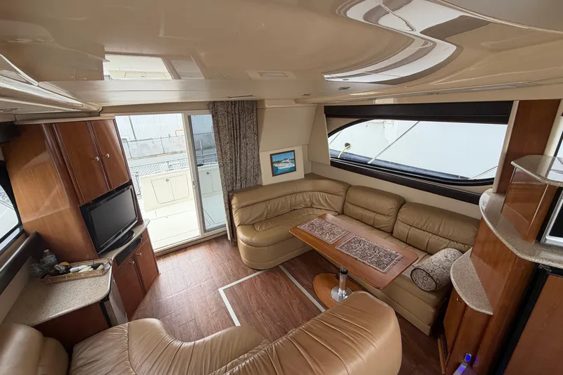 Slide: The Image of Luxurious interior of a 2006 Meridian 411 Sedan yacht with leather seating and wood accents. - 34