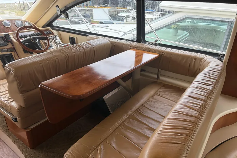 Slide: The Image of Luxurious interior of a 2006 Meridian 411 Sedan yacht with leather seating and wooden table. - 35