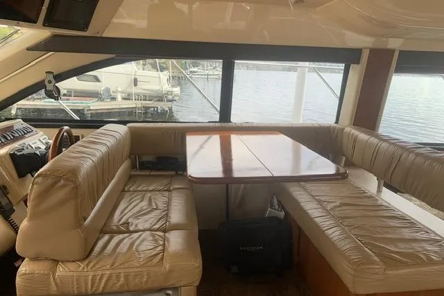 Slide: The Image of Interior of 2006 Meridian 411 Sedan yacht with leather seating and wooden table. - 36