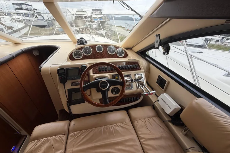 Slide: The Image of 2006 Meridian 411 Sedan helm with leather seating, wooden steering wheel, and navigational instruments. - 37