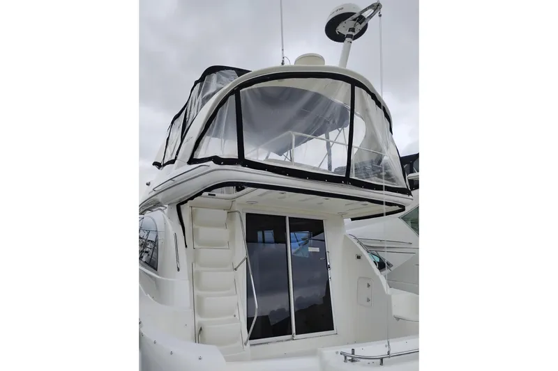 Slide: The Image of 2006 Meridian 411 Sedan yacht with enclosed flybridge, viewed from the stern. - 4