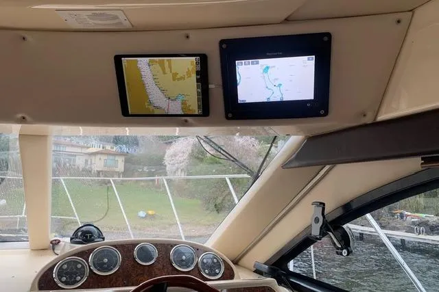 Slide: The Image of Interior view of a 2006 Meridian 411 Sedan yacht dashboard with navigation screens. - 43