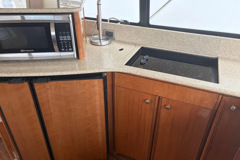 Slide: The Image of Kitchen area of a 2006 Meridian 411 Sedan with microwave and wooden cabinets. - 47