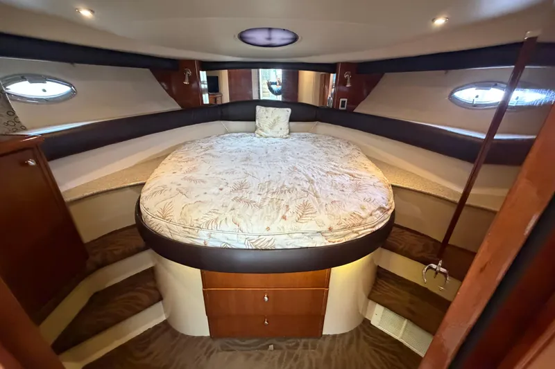 Slide: The Image of Luxurious bedroom interior of a 2006 Meridian 411 Sedan yacht with circular bed and elegant wood finish. - 51
