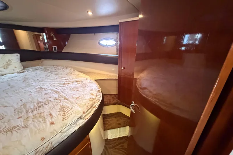 Slide: The Image of Luxurious cabin interior of a 2006 Meridian 411 Sedan yacht with plush bedding. - 52