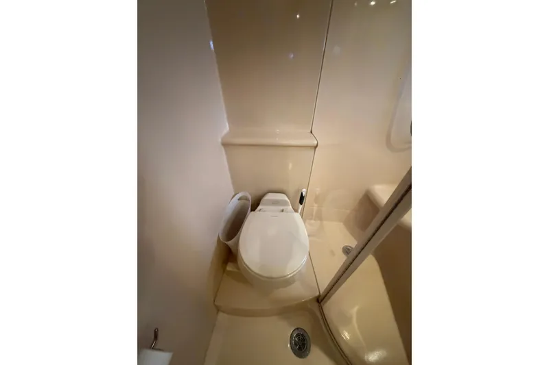 Slide: The Image of Bathroom interior of 2006 Meridian 411 Sedan yacht, featuring a compact toilet. - 58