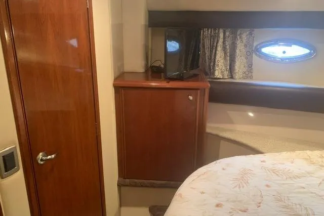 Slide: The Image of Interior cabin of 2006 Meridian 411 Sedan with wood cabinetry and porthole window. - 59