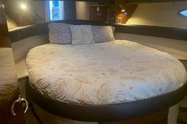 Slide: The Image of Cozy bedroom in 2006 Meridian 411 Sedan yacht with round bed and floral bedding. - 60