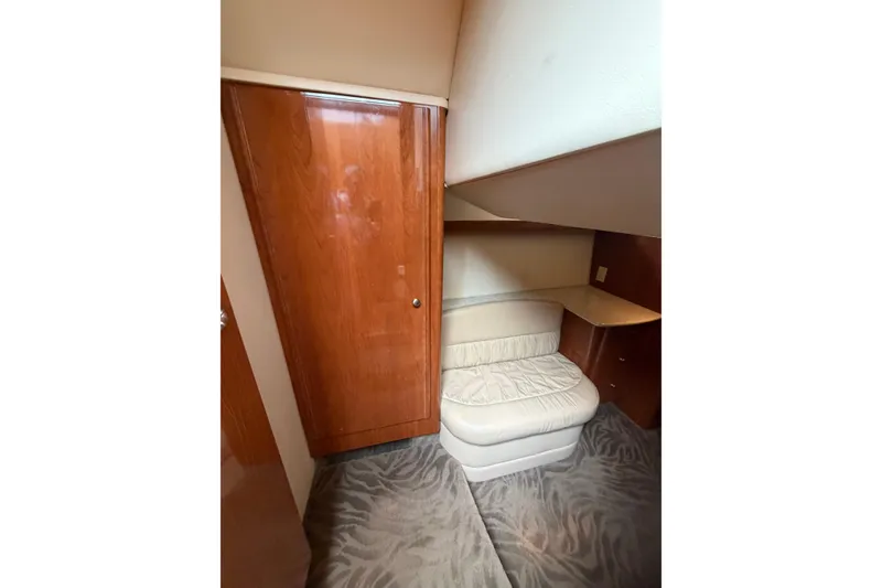 Slide: The Image of Interior of 2006 Meridian 411 Sedan yacht with wooden cabinetry and cushioned seating. - 62