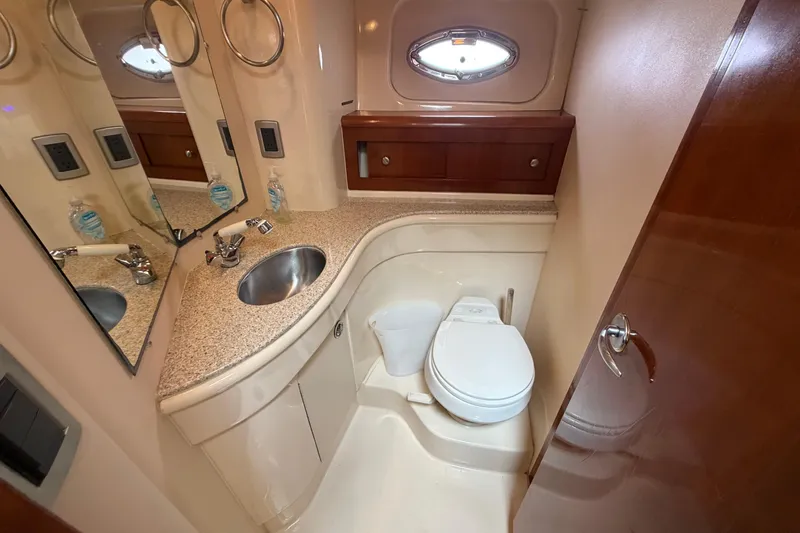 Slide: The Image of Luxurious bathroom in a 2006 Meridian 411 Sedan yacht, featuring modern fixtures and elegant design. - 63