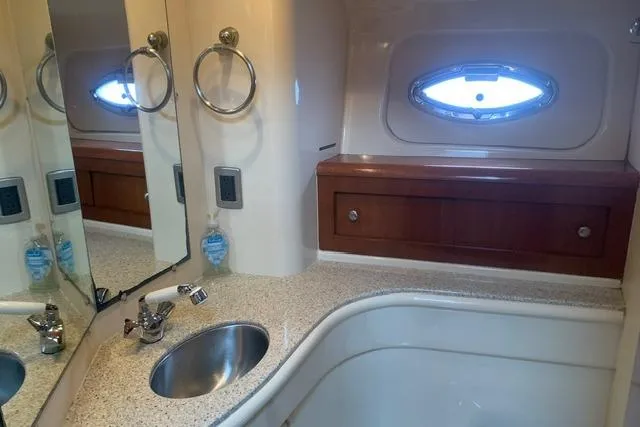 Slide: The Image of Luxurious bathroom in 2006 Meridian 411 Sedan yacht with sink and porthole window. - 64