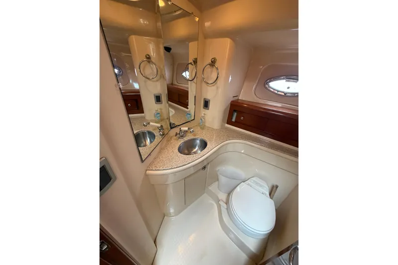Slide: The Image of Luxurious bathroom in 2006 Meridian 411 Sedan yacht with sink, toilet, and mirror. - 66