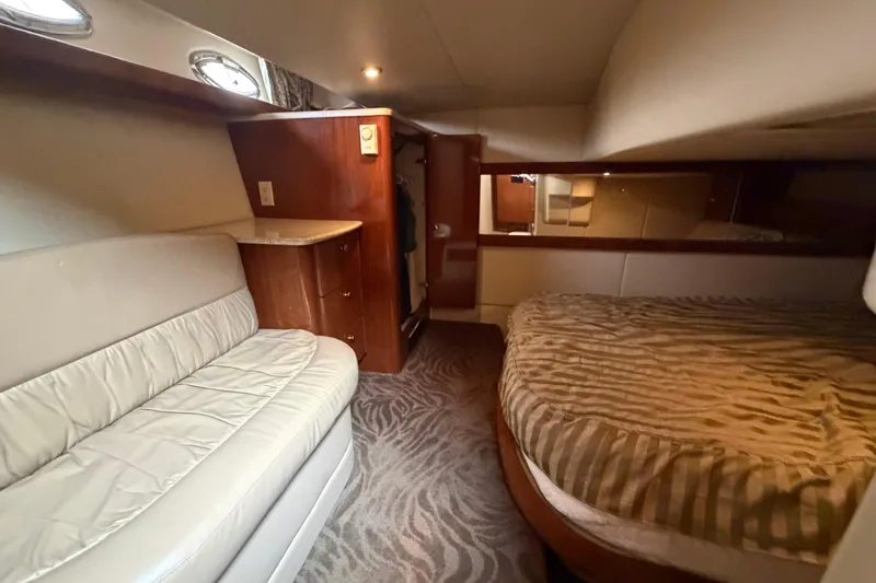 Slide: The Image of Interior of 2006 Meridian 411 Sedan yacht with bed, sofa, and wooden cabinetry. - 68