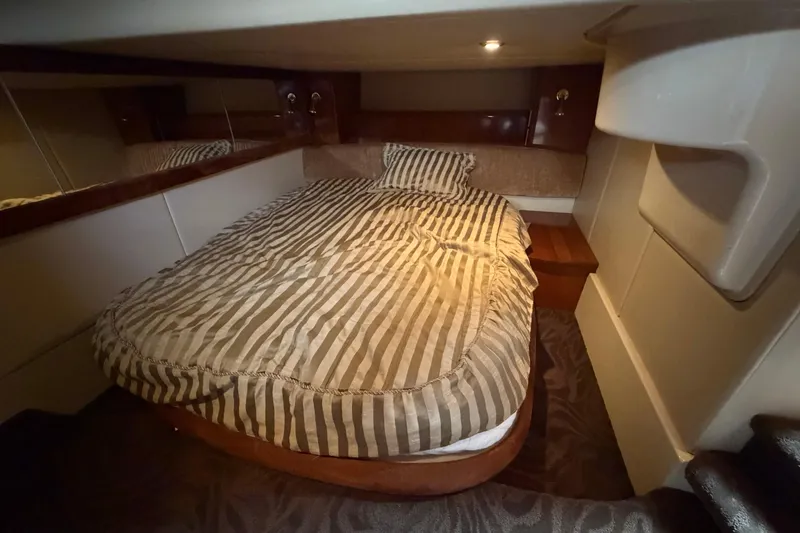 Slide: The Image of Cozy cabin interior of 2006 Meridian 411 Sedan with striped bedding. - 70