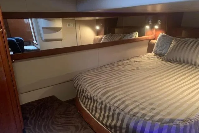 Slide: The Image of Luxurious bedroom interior of 2006 Meridian 411 Sedan yacht with striped bedding. - 71