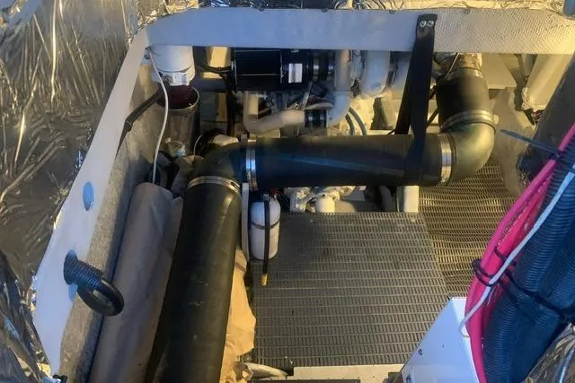 Slide: The Image of Engine room of a 2006 Meridian 411 Sedan yacht, showcasing mechanical components and piping. - 73