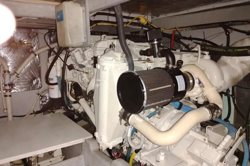 Slide: The Image of Engine room of a 2006 Meridian 411 Sedan yacht, showcasing mechanical components and piping. - 76