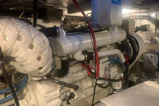 Slide: The Image of Engine room of a 2006 Meridian 411 Sedan yacht, showcasing mechanical components. - 77