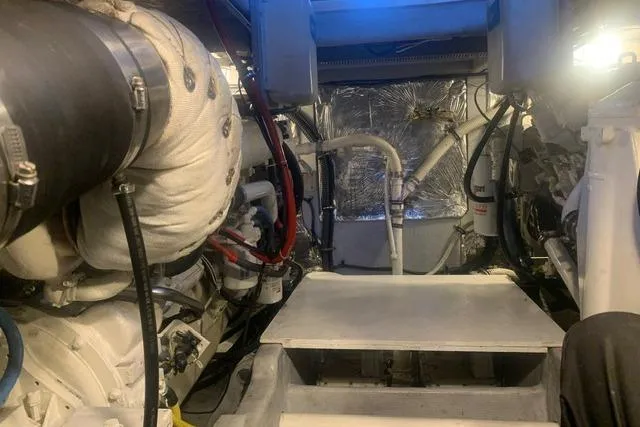 Slide: The Image of Engine room of a 2006 Meridian 411 Sedan yacht, showcasing mechanical components and insulation. - 78