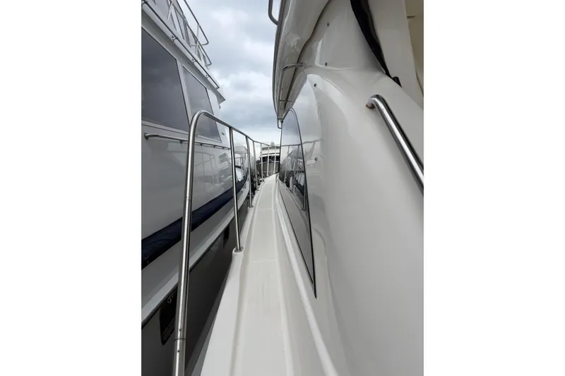 Slide: The Image of Side view of a 2006 Meridian 411 Sedan yacht with sleek design and railing. - 8