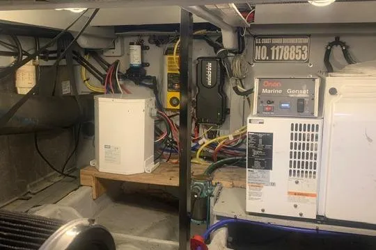 Slide: The Image of Engine room of a 2006 Meridian 411 Sedan with marine generator and electrical components. - 80
