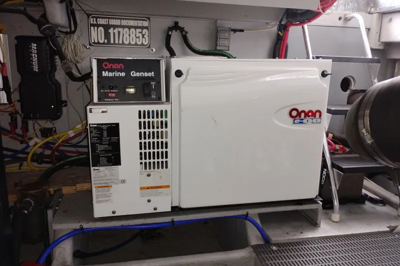 Slide: The Image of Onan Marine Genset in 2006 Meridian 411 Sedan engine room, with wiring and documentation. - 82