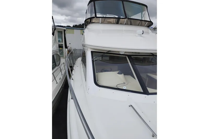 Slide: The Image of 2006 Meridian 411 Sedan yacht with sleek white exterior and spacious deck. - 85