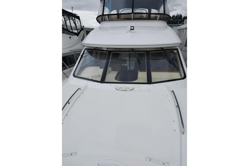 Slide: The Image of 2006 Meridian 411 Sedan yacht with sleek white exterior and tinted windows. - 86