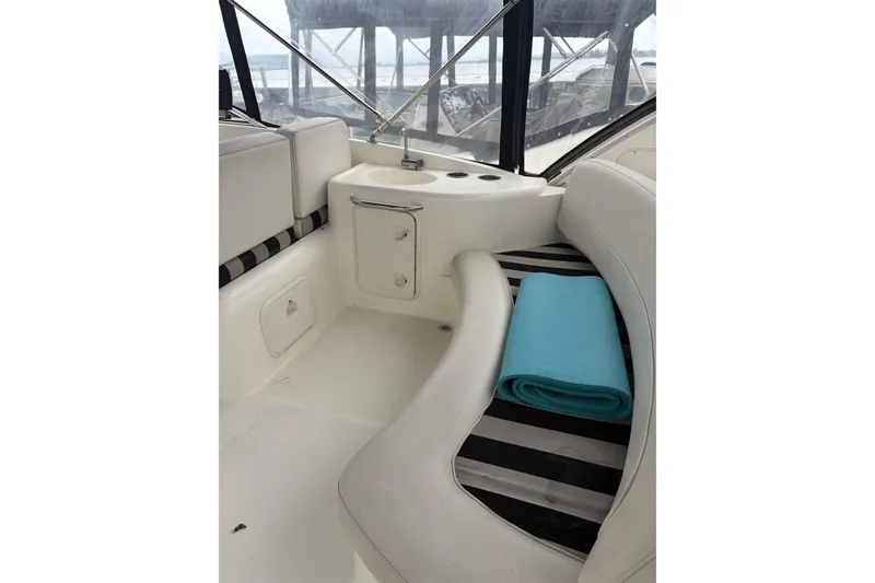 Slide: The Image of Interior of 2006 Meridian 411 Sedan yacht with seating and a rolled blue mat. - 9