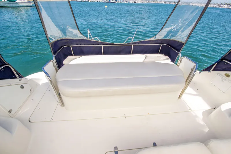Slide: The Image of 2003 Regal Commodore 4260 yacht interior with cushioned seating and ocean view. - 12