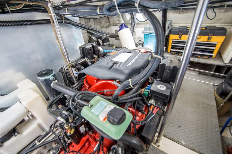 Slide: The Image of Engine room of 2003 Regal Commodore 4260 with Volvo Penta engine and organized tools. - 25