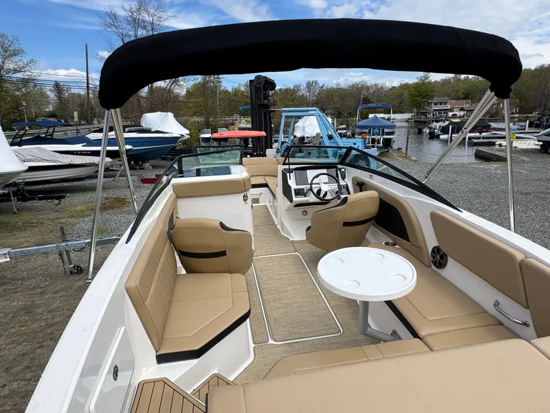 Slide: The Image of Interior of a 2021 Sea Ray 230SPX boat with steering wheel and seat. - 14
