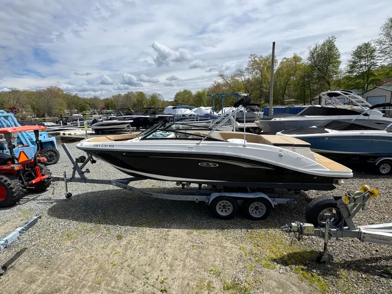 Slide: The Image of Interior of a 2021 Sea Ray 230SPX boat with steering wheel and seats. - 16