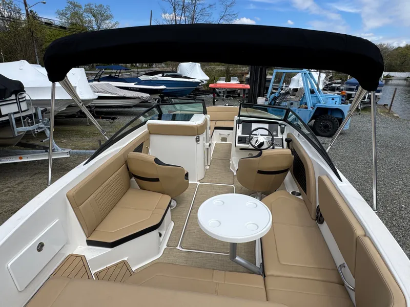 Slide: The Image of Interior of a 2021 Sea Ray 230SPX boat with beige seating. - 20