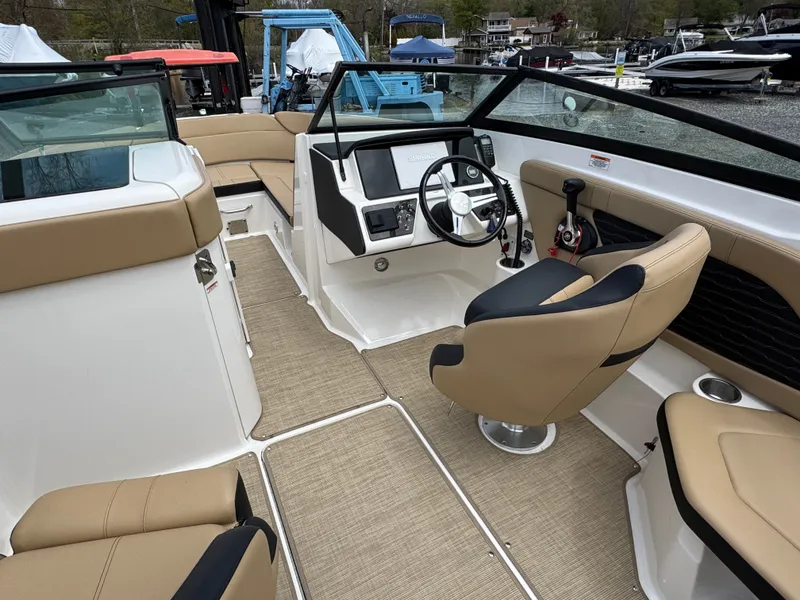 Slide: The Image of Interior of a 2021 Sea Ray 230SPX boat with beige seating. - 23