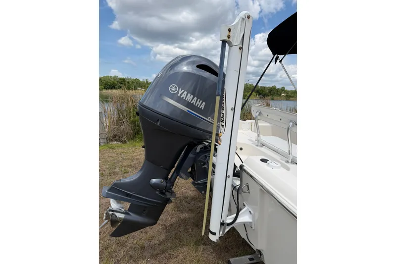 Slide: The Image of 2016 Bulls Bay 2000 boat with Yamaha outboard motor, docked near grassy shoreline. - 13