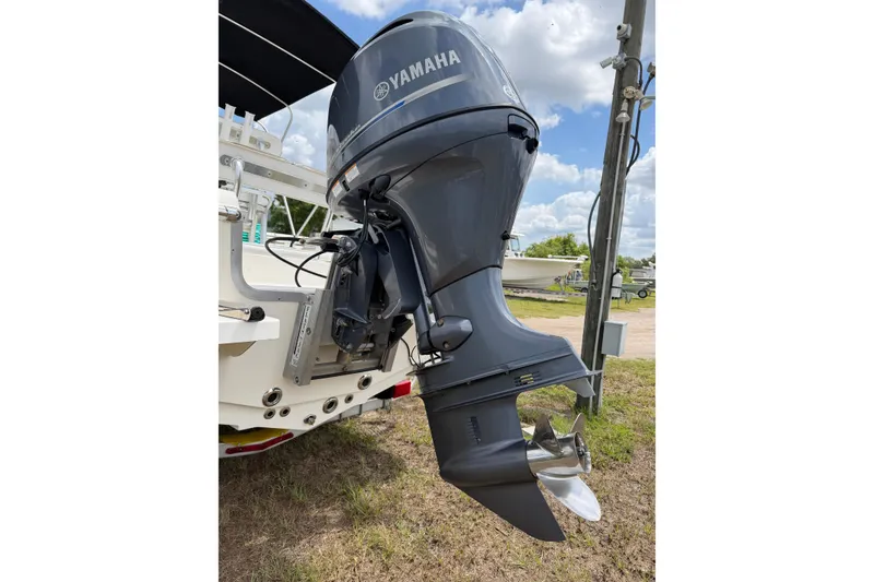 Slide: The Image of Yamaha outboard motor on 2016 Bulls Bay 2000 boat, parked outdoors under blue sky. - 14